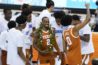 Texas guard Matt Coleman III (2) celebrates with teammates after they defeated North Carolina in an NCAA college basketball game for the championship of the Maui Invitational, Wednesday, Dec. 2, 2020, in Asheville, N.C. (AP Photo/Kathy Kmonicek)