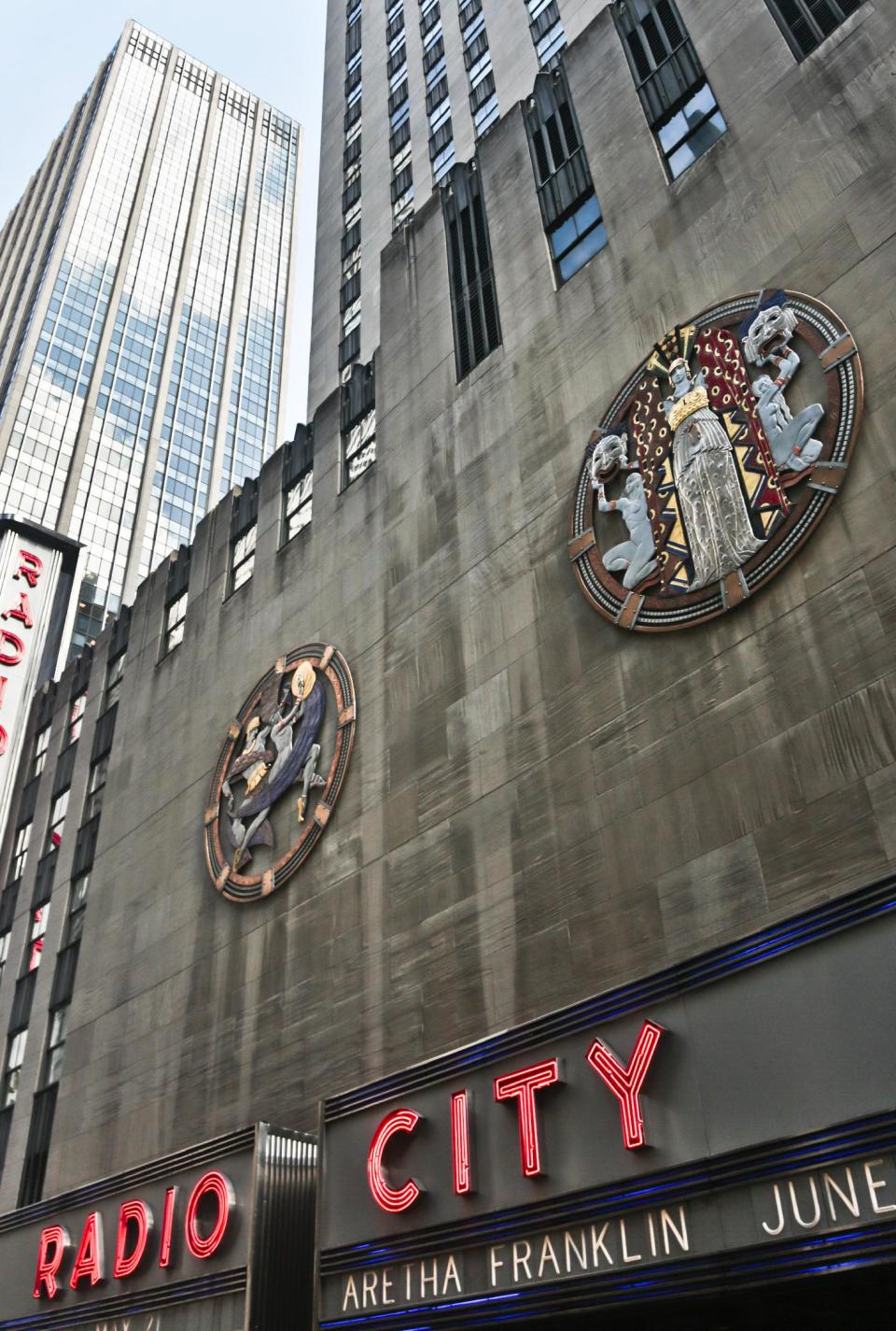 In this March 24, 2014 photo, colossal metal-and-enamel roundels created by art deco muralist Hildreth Meiere stand out on the facade of Radio City Music Hall in New York. “The Art Deco Murals of Hildreth Meiere,” a new book on the trail-blazing muralist who completed over 100 commissions in 16 states before her death in 1961, is set for May 1. (AP Photo/Bebeto Matthews)