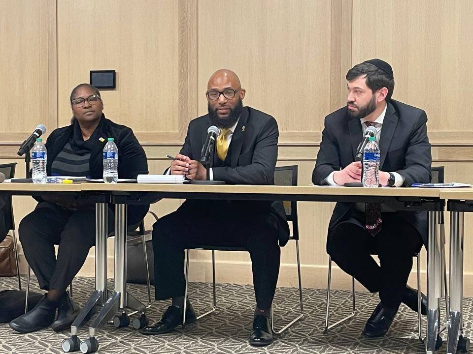 Julius Rhodes, center, sits between Common Council members Sharon McBride, left, and Eli Wax during his public interview Monday night for police review office director.