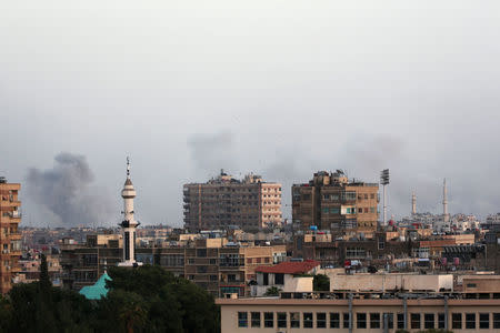 Smoke rises from Yarmouk Palestinian camp in Damascus, Syria April 19, 2018. REUTERS/Ali Hashisho