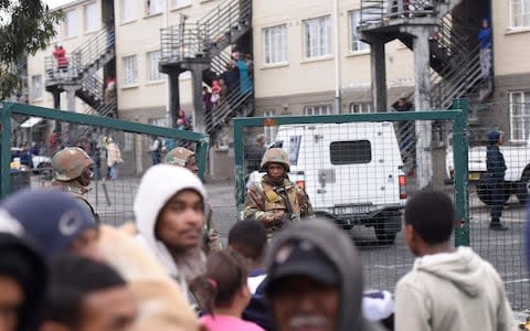 Crowds watch soldiers and police patrol Hanover Park town ship on Thursday - Credit: Brenton Geach/The Telegraph&nbsp;