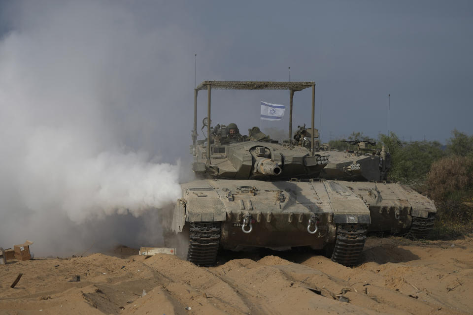 Israeli tanks manoeuvre near the Israeli-Gaza border, southern Israel, Monday, Nov. 13, 2023. (AP Photo/Tsafrir Abayov)