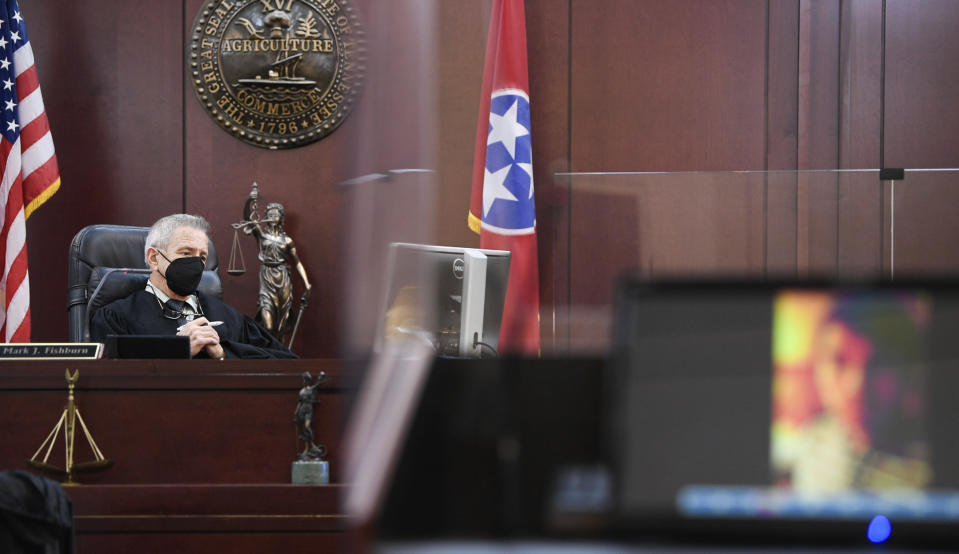 Judge Mark Fishburn reviews the YouTube video of Travis Reinking describing the day he was having, believing someone broke into his home, lifted the toilet seat up and touched his laptop, in court on day four of the mass murder trial at Justice A.A. Birch Building in Nashville, Tenn., Thursday, Feb. 3, 2022. (Stephanie Amador/The Tennessean via AP, Pool)