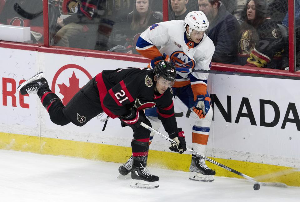 Ottawa Senators right wing Mathieu Joseph steals the puck away from New York Islanders defenseman Samuel Bolduc during the second period of an NHL hockey game, Wednesday, Jan. 25, 2023 in Ottawa, Ontario. (Adrian Wyld/The Canadian Press via AP)