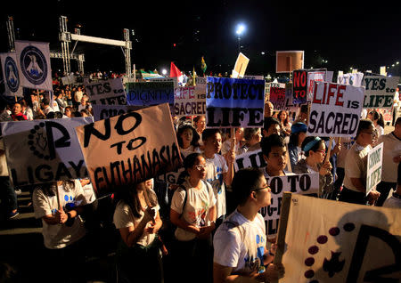 Participants display placards as they participate in a procession against plans to reimpose death penalty and intensify drug war during "Walk for Life" in Luneta park, Metro Manila, Philippines February 24, 2018. REUTERS/Romeo Ranoco