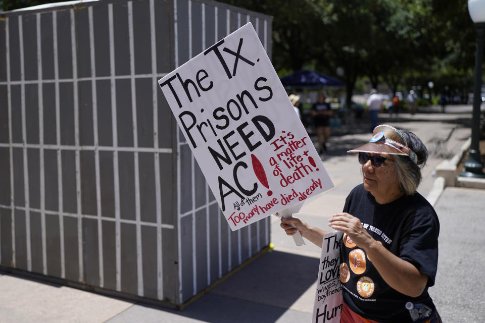 An advocate for cooling Texas prisons walks past a makeshift cell during a rally on the steps of the Texas Capitol, Tuesday, July 18, 2023, in Austin, Texas. The group is calling for an emergency special session to address the deadly heat effecting inmates. (AP Photo/Eric Gay)