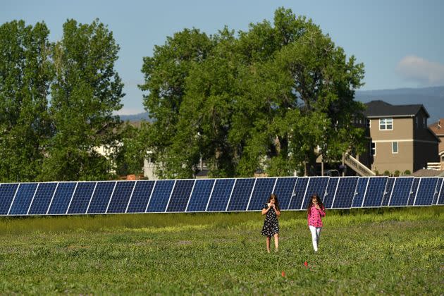 The daughter of state Sen. Kevin Priola and the daughter of SunShare's director of legislative affairs Corrina Kumpe walk among the solar panels at the JeffCo Community Solar Garden in Arvada, Colorado, on May 30, 2019. Priola announced he is switching party affiliations on Aug. 22, 2022, citing the GOP's peddling of election lies and its refusal to work on climate policy. (Photo: Joe Amon/MediaNews Group/The Denver Post via Getty Images)