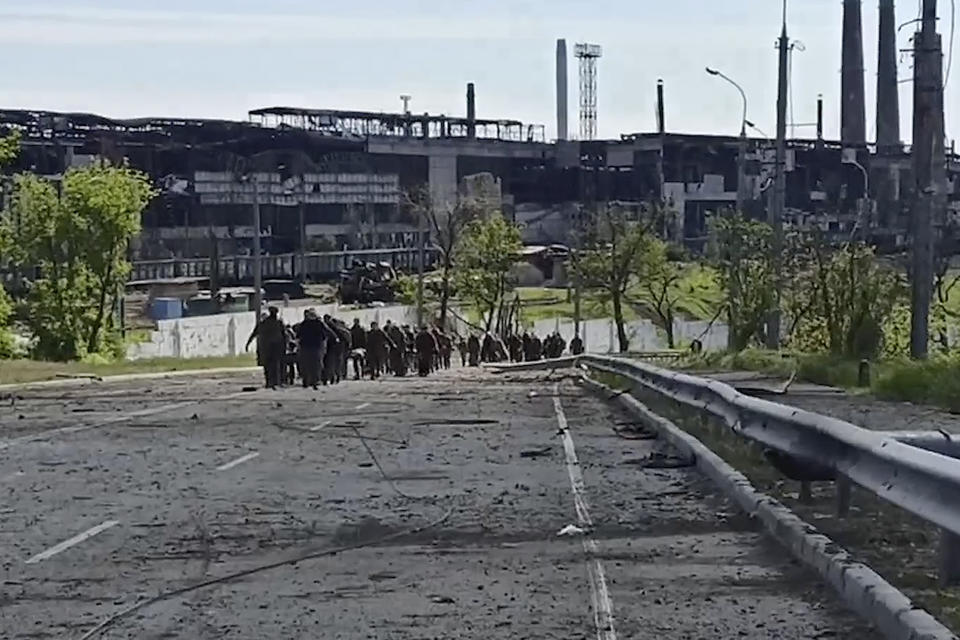 In this photo taken from video released by the Russian Defense Ministry Press Service on Wednesday, May 18, 2022, Ukrainian servicemen leave the besieged Azovstal steel plant in Mariupol, Ukraine. (Russian Defense Ministry Press Service via AP)