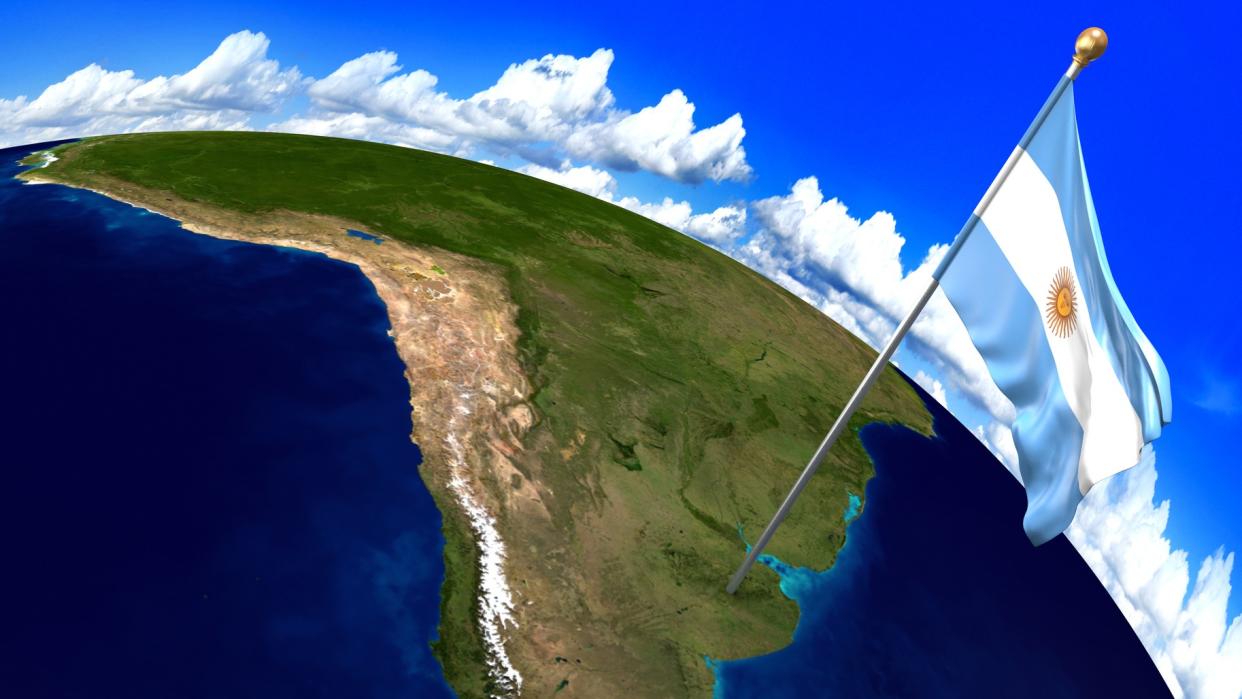  illustration of south america from space. blue skies and clouds surround the curvature of the earth. a gigantic, not to scale argentina flag with a post is planted about where argentina would be on the map 