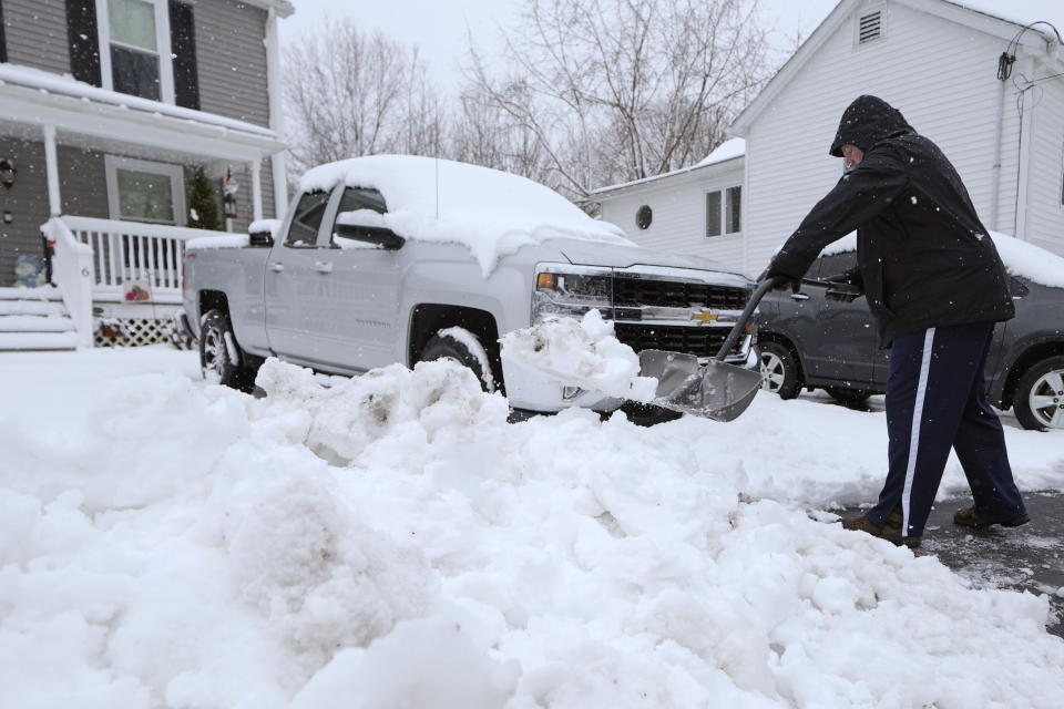 Steve Dickens, of Derry, N.H. shovels snow, Thursday, April 4, 2024, in Derry, N.H. Parts of New Hampshire received over a foot of snow from the storm. (AP Photo/Charles Krupa)