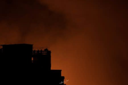 Flames engulf a slum after a fire broke out in Dhaka