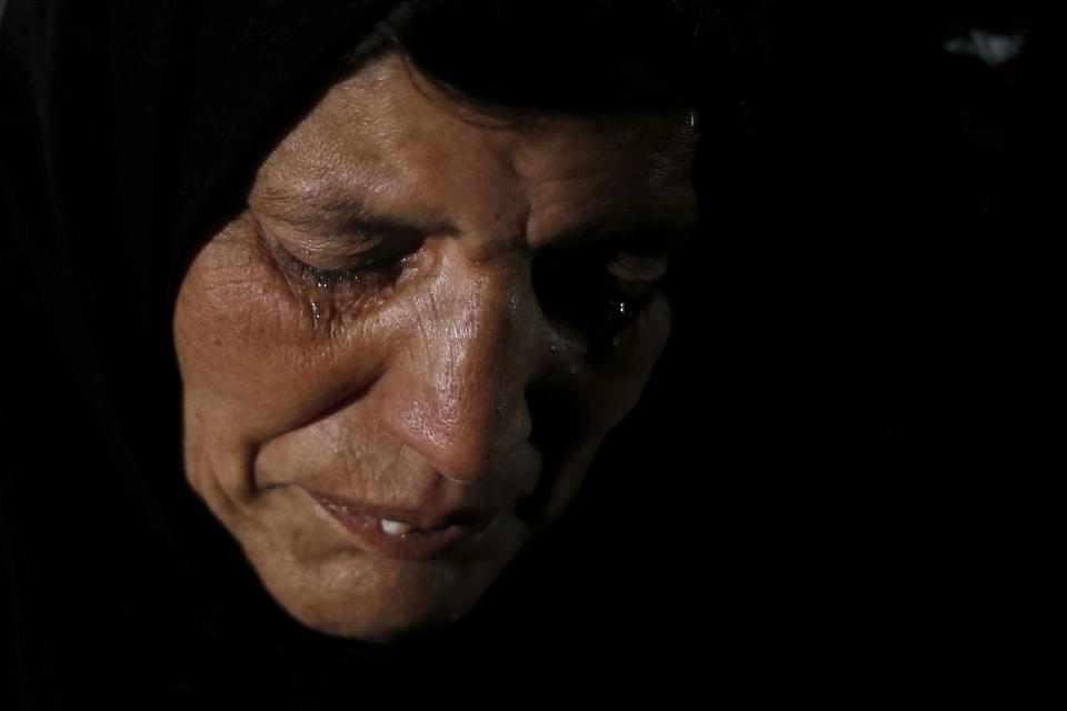 In this Tuesday, Dec. 18, 2018, photo, Syrian refugee Itihad Sayed weeps during an interview with The Associated Press at her home in Ouzai refugee compound, in the southern port city of Sidon, Lebanon. A much touted Russian initiative to facilitate the return of Syrian refugees has fizzled out, with the return of only about 114,000 Syrians - out of more than 5 million in the region and Europe. In Lebanon, which hosts the highest ratio of refugees per capita, most of the estimated 1.2 million Syrians say the intend to stay put, citing economic concerns, ongoing fighting and destroyed homes. (AP Photo/Bilal Hussein)