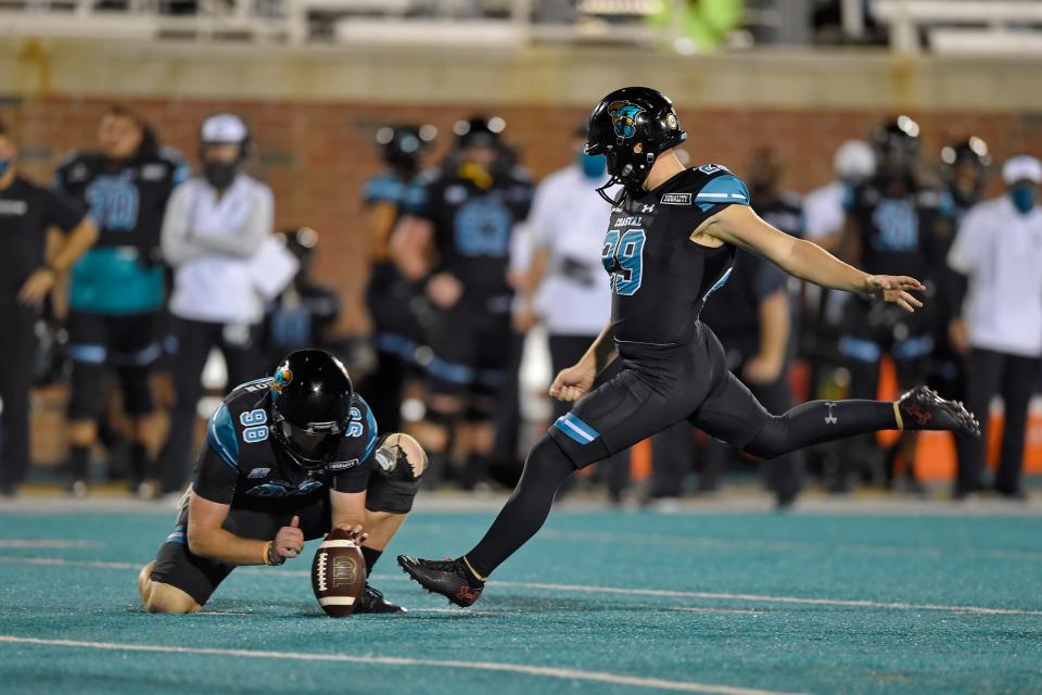 Coastal Carolina's Massimo Biscardi (29) kicks a field goal while Charles Ouverson holds during the second half of an NCAA college football game against South Alabama, Saturday, Nov. 7, 2020, in Conway, S.C. (AP Photo/Richard Shiro)