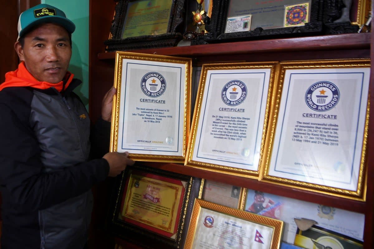 Nepal’s mountaineer Kami Rita Sherpa poses with his Guinness World Record certificates (AFP via Getty Images)