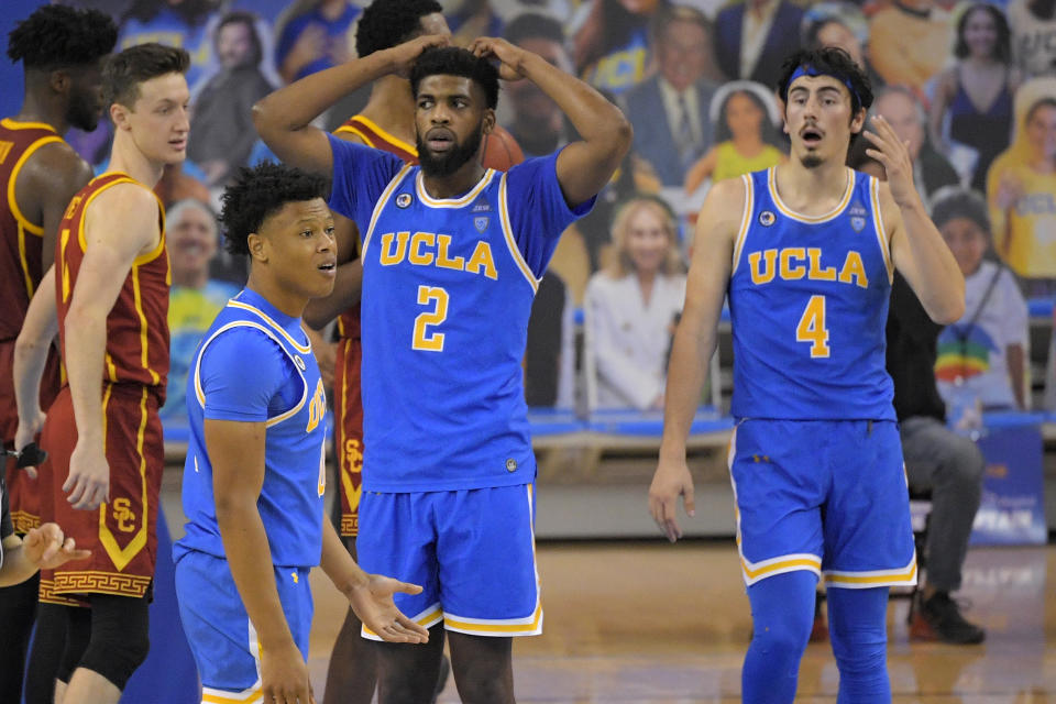UCLA guard Jaylen Clark, second from left, forward Cody Riley, second from right, and guard Jaime Jaquez Jr., right, react to a foul call as Southern California guard Drew Peterson, left, looks on during the second half of an NCAA college basketball game Saturday, March 6, 2021, in Los Angeles. USC won 64-63. (AP Photo/Mark J. Terrill)