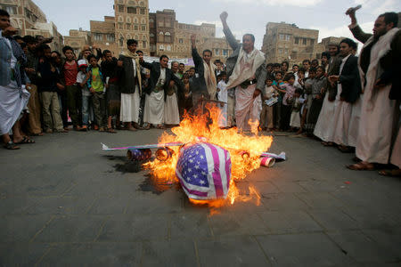 FILE PHOTO: Protesters loyal to the Shi'ite al-Houthi rebel group burn an effigy of a U.S. aircraft during a demonstration to protest against what they say is U.S. interference in Yemen, including drone strikes, after their weekly Friday prayers in the Old Sanaa city April 12, 2013. REUTERS/Khaled Abdullah/File Photo