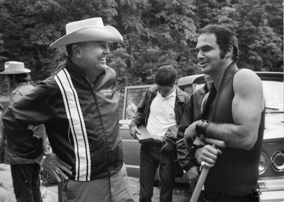 Poet, novelist and screenwriter James Dickey chats with star Burt Reynolds on the set of 1972's "Deliverance."