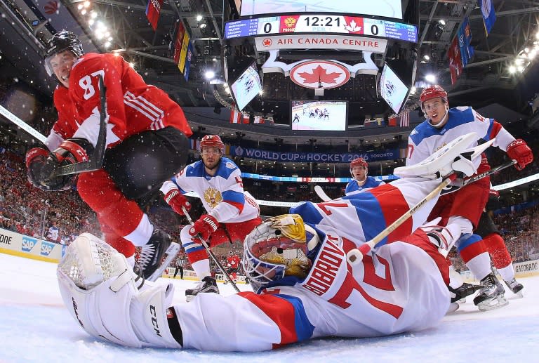 Sidney Crosby (L) of Team Canada scores past a diving Sergei Bobrovsky of Team Russia in the semi-final of the World Cup of Hockey in Toronto, Canada