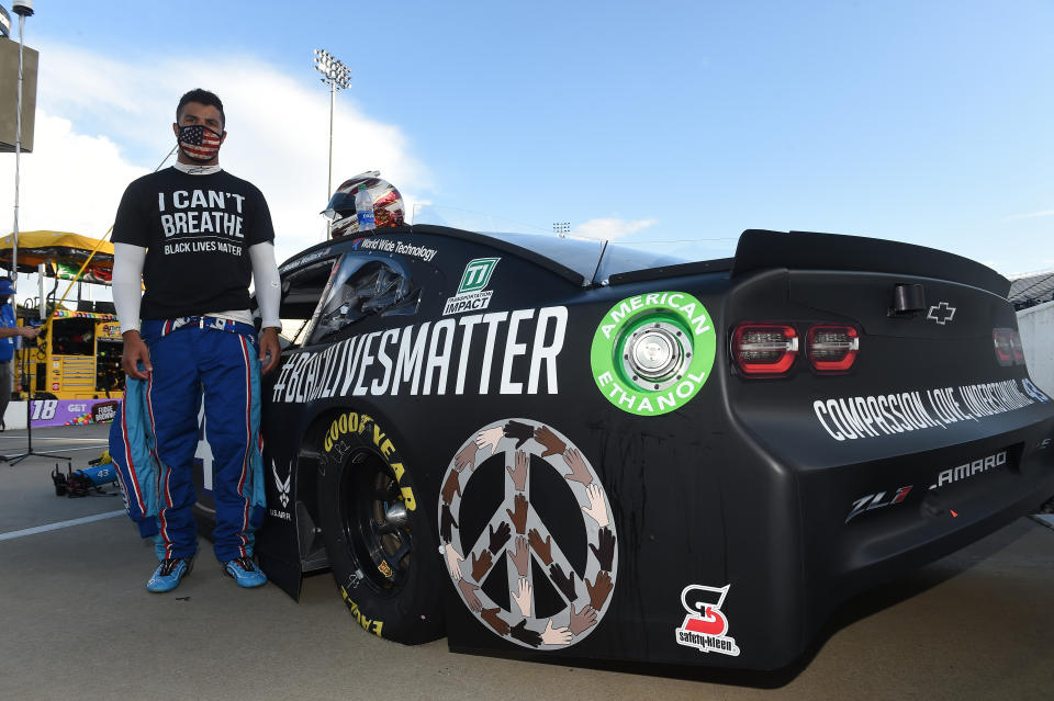 MARTINSVILLE, VIRGINIA - JUNE 10: Bubba Wallace, driver of the #43 Richard Petty Motorsports Chevrolet, wears a "I Can't Breathe - Black Lives Matter" t-shirt under his fire suit in solidarity with protesters around the world taking to the streets after the death of George Floyd on May 25 , stands next to his car painted with "#Black Lives Matter" prior to the NASCAR Cup Series Blue-Emu Maximum Pain Relief 500 at Martinsville Speedway on June 10, 2020 in Martinsville, Virginia. (Photo by Jared C. Tilton/Getty Images)