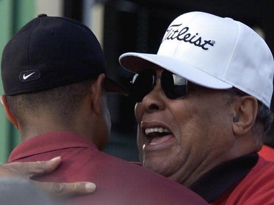 Woods start his fairy tale relationship with the Masters alongside his father Earl (Getty)