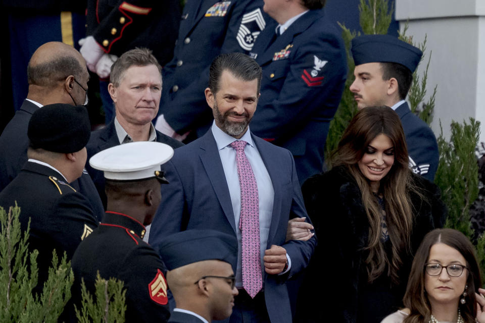 Donald Trump, Jr., center, and Kimberly Guilfoyle, right, arrive for the inauguration of Louisiana Republican Gov. Jeff Landry at the State Capitol building in Baton Rouge, La., Sunday, Jan. 7, 2024. The ceremony was moved because of forecasted rain on Monday, Jan. 8, the actual date Landry officially becomes governor. (AP Photo/Matthew Hinton)
