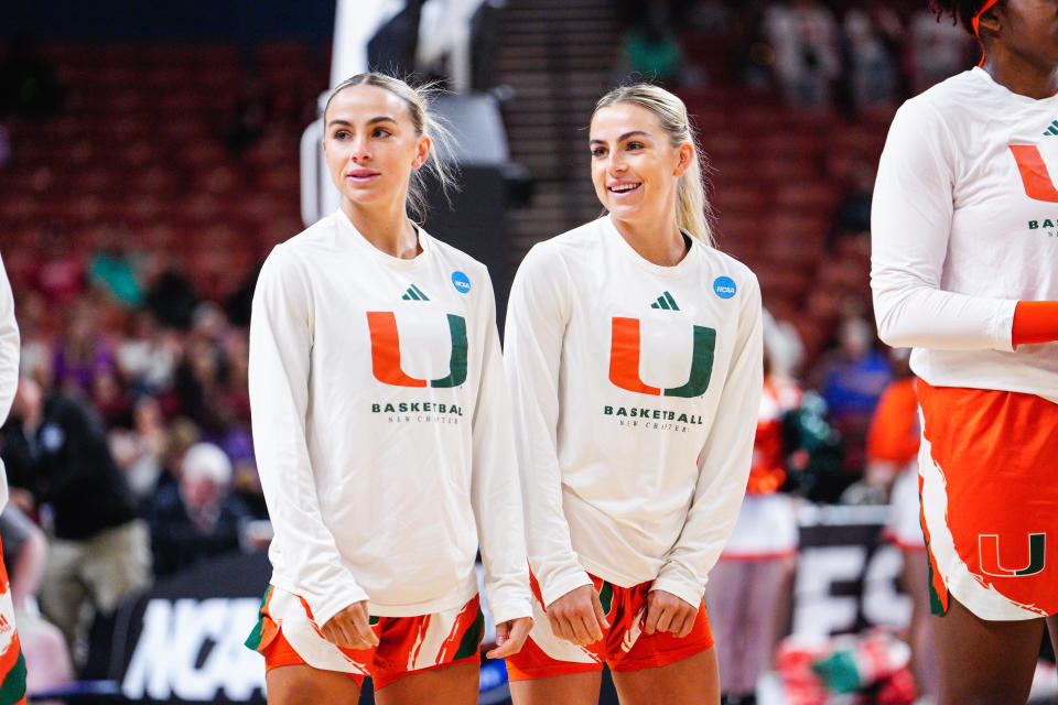 GREENVILLE, SC - MARCH 24: Haley Cavinder #14 of the Miami Hurricanes and Hanna Cavinder #15 of the Miami Hurricanes during pregame during the Sweet Sixteen round of the 2023 NCAA Womens Basketball Tournament held at Bon Secours Wellness Arena on March 24, 2023 in Greenville, South Carolina. (Photo by Jacob Kupferman/NCAA Photos via Getty Images)