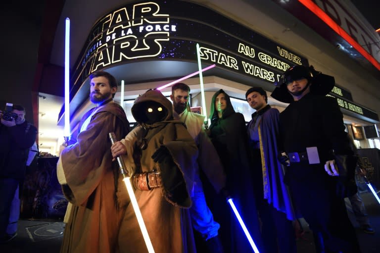 People wearing Star Wars costumes wait at the Grand Rex cinema in Paris for the French release of "Star Wars: The Force Awakens on December 16, 2015