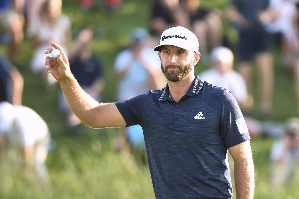 Dustin Johnson, of the United States, salutes the crowd on the 18th green after winning the Canadian Open at the Glen Abbey Golf Club in Oakville, Ontario, Sunday, July 29, 2018. (Nathan Denette/The Canadian Press via AP)