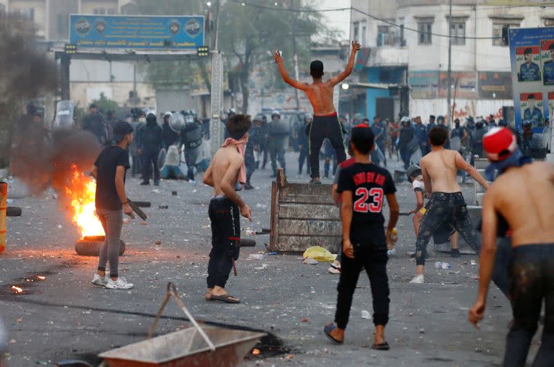 Iraqi demonstrators clash with Iraqi security forces during a protest over poor public services in Baghdad