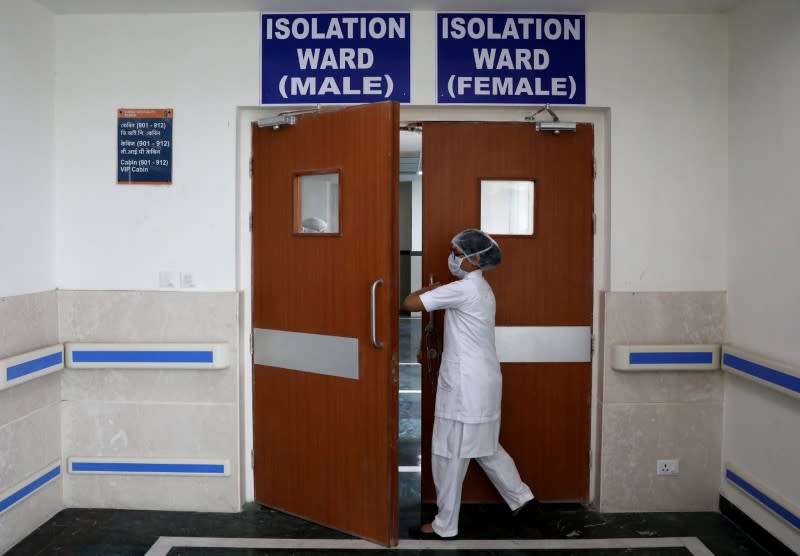 A paramedic staff member enters a newly setup isolation ward at a hospital in Kolkata