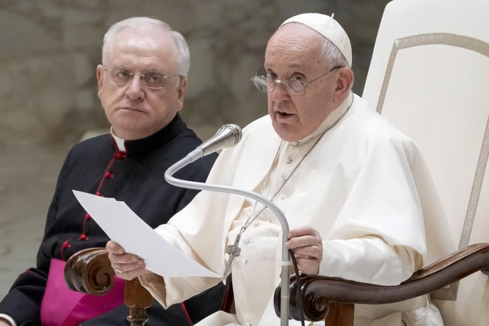 Pope Francis flanked by Father Leonardo Sapienza, left, delivers his speech during his weekly general audience in the Paul VI hall at The Vatican, Wednesday, Aug. 30, 2023. Pope Francis is traveling to Mongolia this week to minister to one of the world's tiniest and newest Catholic communities, the first-ever visit by a Roman pontiff to the East Asian country. His trip is a historic meeting of East and West. Officially, there are only 1,450 Catholics in Mongolia and the Catholic Church has only had a sanctioned presence since 1992, after Mongolia shrugged off its Soviet-allied communist government. (AP Photo/Andrew Medichini)