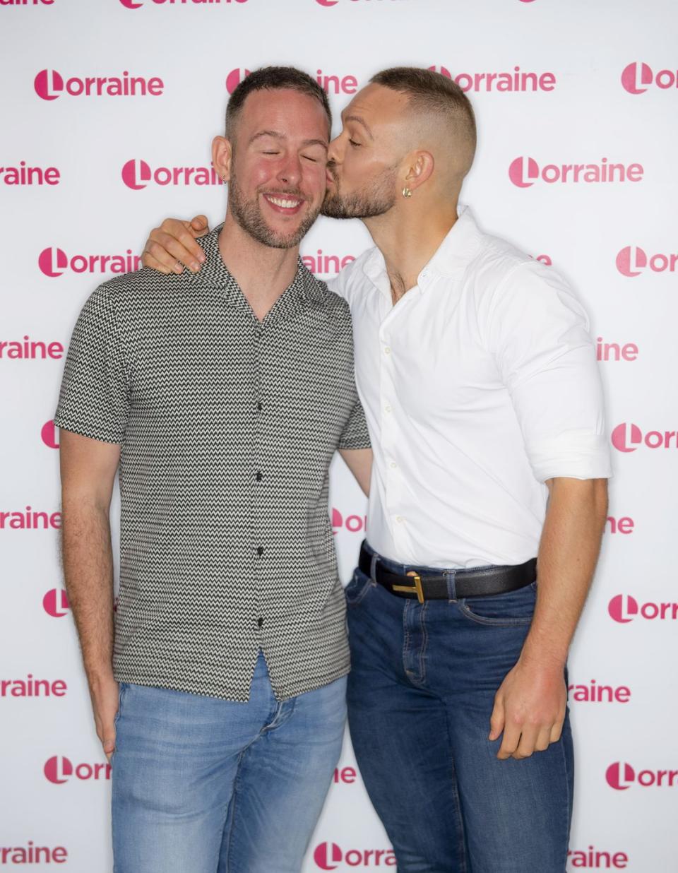 john whaite kissing his partner paul atkins on the cheek