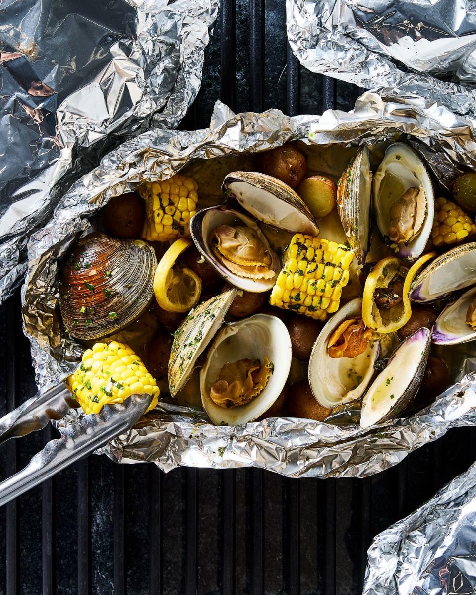 clams, corn, and potatoes in a grilled foil pack