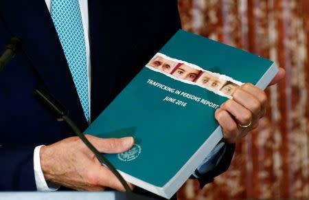 U.S. Secretary of State John Kerry holds a copy of the 2016 Trafficking in Persons (TIP) report during the TIP Heroes Ceremony at the State Department in Washington, June 30, 2016. REUTERS/Kevin Lamarque