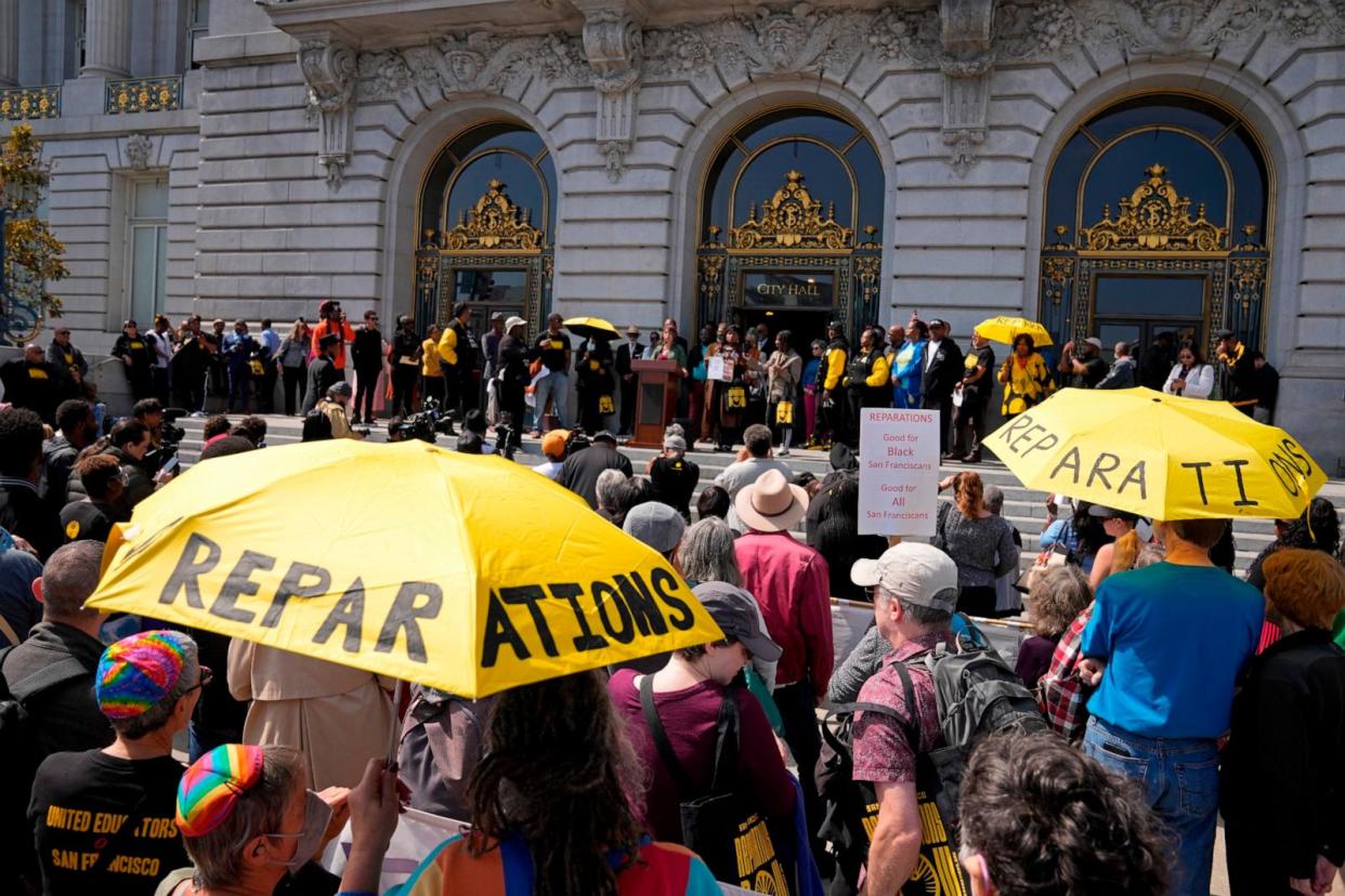 PHOTO: People listen during a rally in support of reparations for African Americans outside City Hall in San Francisco, Sept. 19, 2023.   (Eric Risberg/AP)