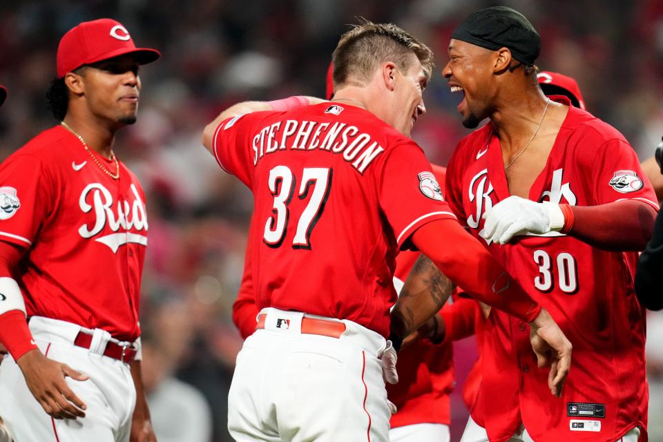 Cincinnati Reds left fielder Will Benson (30) is congratulated at home plate after hitting a walk-off, two-run home run in the ninth inning of a baseball game between the Los Angeles Dodgers and the Cincinnati Reds, Wednesday, June 7, 2023, at Great American Ball Park in Cincinnati. 