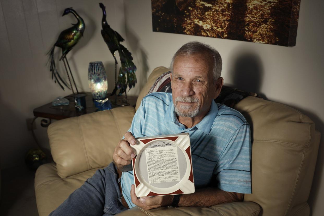 Mike Frailey holds an ashtray printed with a miniaturized copy of the Naval Station Guantanamo Bay evacuation letter given families at the base during the Cuban Missile Crisis. He was 10 years old in 1962 when he, his two brothers and mother boarded a troop carrier that took them to Norfolk, Va. His father Julius, an officer, stayed behind and had a role in that letter.