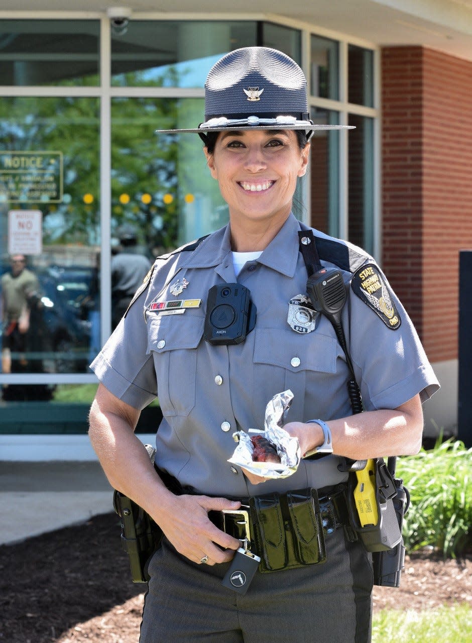 Trooper Cindy Witt enjoys a $1 hot dog at the Ohio Turnpike’s Commodore Perry Service Plaza on May 26. The hot dog stand was just one of many amenities the turnpike offered to show its appreciation to customers.