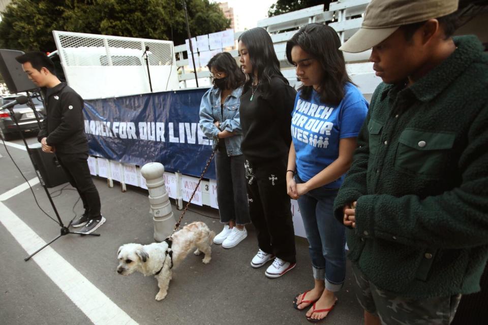 Five people in front of a March for Our Lives sign