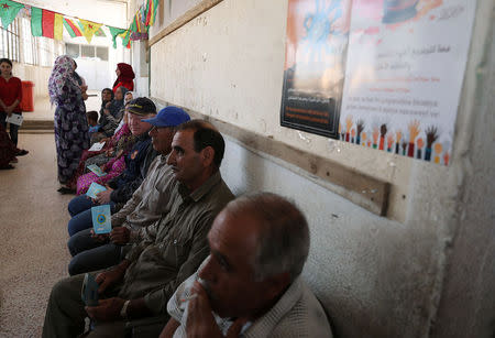 People sit at a polling station in Qamishli, Syria September 22, 2017. REUTERS/Rodi Said