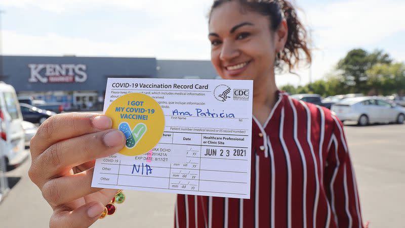 Ana Patricia Jenkins holds her vaccination record card after receiving a COVID-19 vaccination at a pop-up clinic sponsored by the Davis County Health Department in the parking lot of Kent’s Market in Clearfield on June 23, 2021.
