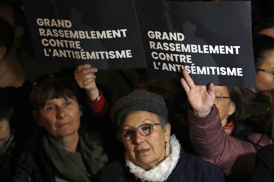 People gather at the Republique square to protest against anti-Semitism, in Paris, France, Tuesday, Feb. 19, 2019. In Paris and dozens of other French cities, ordinary citizens and officials across the political spectrum geared up Tuesday to march and rally against anti-Semitism, following a series of anti-Semitic acts that shocked the nation. (AP Photo/Christophe Ena)