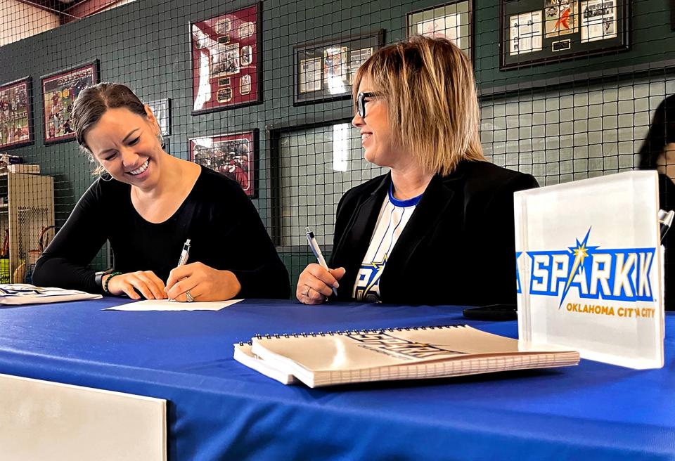 Former OU softball standout Keilani Ricketts, left, sits next to OKC Spark owner Tina Floyd during a signing ceremony in January.