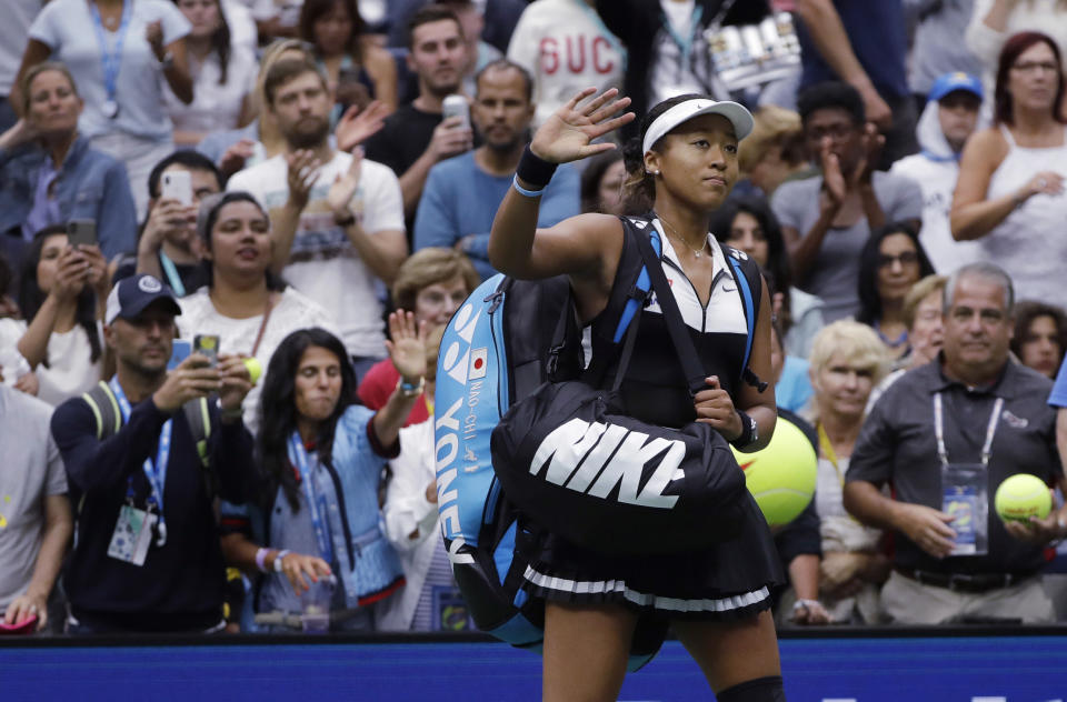 Naomi Osaka, of Japan, waves to the crowd after a 7-5, 6-4 loss to Belinda Bencic, of Switzerland, during the fourth round of the US Open tennis championships Monday, Sept. 2, 2019, in New York. (AP Photo/Frank Franklin II)