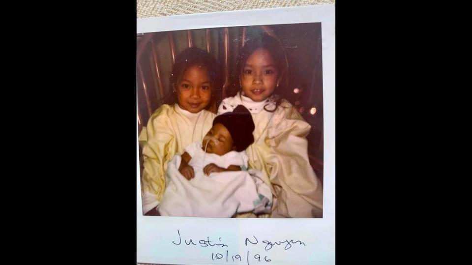 Jennifer, left, and Jessica Pham visit their brother, Justin Nguyen, at the hospital after his birth and emergency surgery.  The nurses would take Justin from his incubator and place him in his sisters’ arms. They could hold him only for a short time because of his delicate condition.