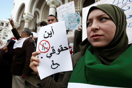 A woman holds a sign during a protest by people with special needs demanding immediate political change and improvement of their living conditions in Algiers, Algeria March 14, 2019. The sign reads: "Where are my rights". REUTERS/Ramzi Boudina