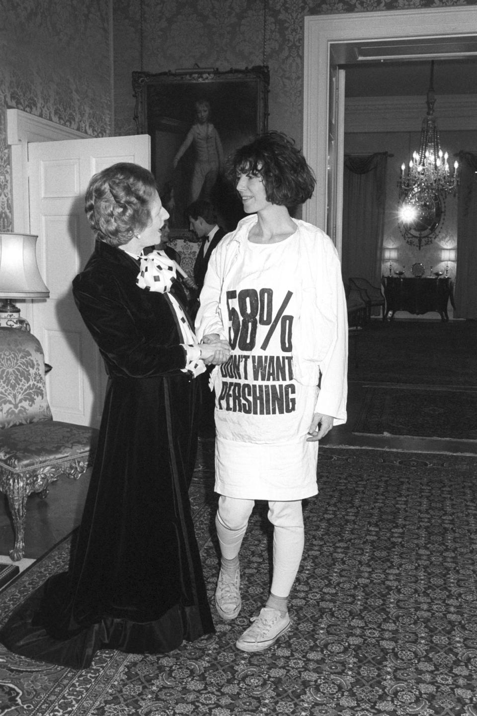 Margaret Thatcher and Katharine Hamnett at a Downing street reception to mark London Fashion Week in 1984 (PA)