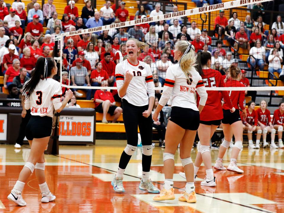 Jerilynn Koehler celebrates a point with Lizzie Ellis, left, and Trinity Cook during New Lexington's 20-25, 21-25, 25-15, 22-25 loss to Union Local in a Division II regional final on Saturday at Heath High School. The Panthers ended a 22-6 season that included its first regional runner-up in school history and its first district title since 1983.