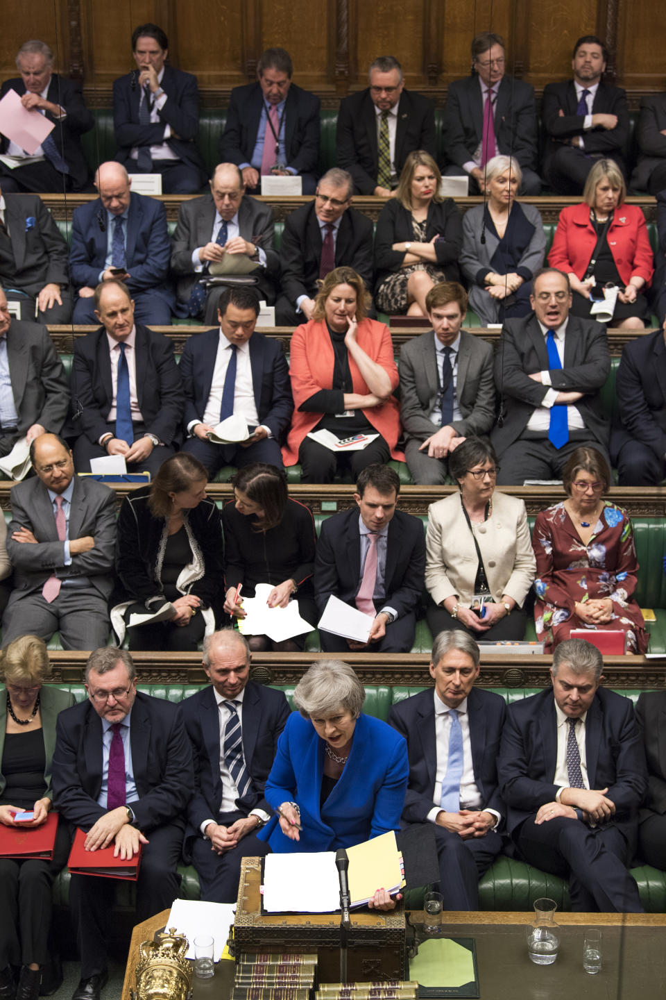 Other ministers look on as Britain's Prime Minister Theresa May speaks during a debate before a no-confidence vote on Theresa May raised by opposition Labour Party leader Jeremy Corbyn, in the House of Commons, London, Wednesday Jan. 16, 2019. In a historic defeat for the government Tuesday, Britain's Parliament discarded May's Brexit deal to split from the European Union, and May now faces a parliamentary vote of no-confidence Wednesday. (Mark Duffy, UK Parliament via AP)