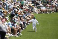 Lucas Glover's son, Lucas Jr. greets fans on the fifth hole during the par-3 contest at the Masters golf tournament at Augusta National Golf Club Wednesday, April 10, 2024, in Augusta, GA. (AP Photo/George Walker IV)